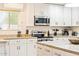 Modern kitchen featuring white cabinets, granite countertops, and stainless steel appliances at 16436 N 64Th Pl, Scottsdale, AZ 85254