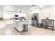 Bright kitchen featuring modern appliances, an island with granite countertops, and tile floors at 16436 N 64Th Pl, Scottsdale, AZ 85254