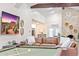 Open living room featuring vaulted ceilings, a brick fireplace, leather seating, and a billiard table at 16436 N 64Th Pl, Scottsdale, AZ 85254