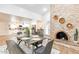 Open floor plan dining and living space with brick fireplace and modern decor at 16436 N 64Th Pl, Scottsdale, AZ 85254