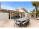 Back patio with seating, a dining table, an outdoor water feature, and a partial view of the pool at 16436 N 64Th Pl, Scottsdale, AZ 85254