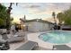 Backyard pool with lounge chairs, lush greenery, and a hot tub at 16436 N 64Th Pl, Scottsdale, AZ 85254