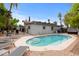 Backyard pool with lounge chairs, lush greenery, and patio area at 16436 N 64Th Pl, Scottsdale, AZ 85254
