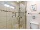 Modern shower with tiled walls, glass enclosure, and built-in niche at 16436 N 64Th Pl, Scottsdale, AZ 85254