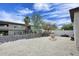 Backyard featuring a fountain, desert landscaping, and a view of surrounding buildings at 16705 E Almont Dr # A, Fountain Hills, AZ 85268
