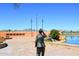 Community landmark featuring a statue, flagpoles, and lake views set against a mountainous backdrop at 16705 E Almont Dr # A, Fountain Hills, AZ 85268