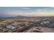 Aerial view of community at sunset featuring shopping center with ample parking and distant mountain views at 21166 W Main St, Buckeye, AZ 85396