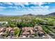 Overhead image displays charming homes near lush greenery, golf course, and stunning mountain views in a serene, vibrant community at 21166 W Main St, Buckeye, AZ 85396