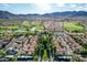 Breathtaking aerial view of the community, showcasing lush golf course, mountains, and residences at 21166 W Main St, Buckeye, AZ 85396