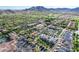 Aerial view of community featuring homes and local shops with mountains in the distance at 21166 W Main St, Buckeye, AZ 85396