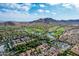 Aerial view of golf course, community, and mountains at 21166 W Main St, Buckeye, AZ 85396