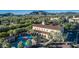 Community aerial view of building with a pool, playground, and lush landscaping set against a mountain backdrop at 21166 W Main St, Buckeye, AZ 85396