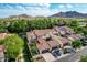 Stunning aerial perspective of the residential community with palm trees, tile roofs and mountain views at 21166 W Main St, Buckeye, AZ 85396