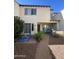 Back exterior view with patio, barbecue, table with chairs and garden at 21166 W Main St, Buckeye, AZ 85396