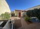 Quaint backyard with brick path, outdoor shed, and lush landscaping at 21166 W Main St, Buckeye, AZ 85396