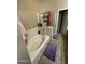 This bathroom features a bathtub, glass shower enclosure, and neutral wall paint at 21166 W Main St, Buckeye, AZ 85396