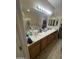This bathroom has a double vanity, a tub and shower combo, and a door to another room at 21166 W Main St, Buckeye, AZ 85396
