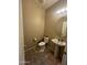 A half bathroom featuring a pedestal sink and tiled floors at 21166 W Main St, Buckeye, AZ 85396