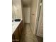 Neutral-toned bathroom with a long vanity and tile flooring at 21166 W Main St, Buckeye, AZ 85396