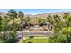Aerial view of the clubhouse and palm trees, set against a desert mountain backdrop at 21166 W Main St, Buckeye, AZ 85396