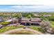 Aerial shot of the golf clubhouse featuring red tile roof, palm trees and a beautiful landscape at 21166 W Main St, Buckeye, AZ 85396