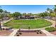 Inviting community park with manicured lawn, mature landscaping and covered picnic and gathering area at 21166 W Main St, Buckeye, AZ 85396
