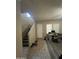 Open-concept entryway featuring tile and wood-style flooring, stairs, and plenty of natural light at 21166 W Main St, Buckeye, AZ 85396