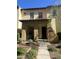 Inviting two-story home with a covered entrance, number visible, and lush greenery at 21166 W Main St, Buckeye, AZ 85396