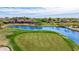 Picturesque view of golf course with bridge and lake, set against a blue sky backdrop at 21166 W Main St, Buckeye, AZ 85396