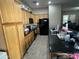 Functional kitchen featuring sleek black appliances, wood cabinets, and ample counter space, ideal for home-cooked meals at 21166 W Main St, Buckeye, AZ 85396