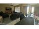 Open concept living space with comfortable seating, a ceiling fan, tv and connecting kitchen area at 21166 W Main St, Buckeye, AZ 85396