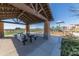 Community picnic area with covered seating, playground, landscaping, and easy access to walking paths at 21166 W Main St, Buckeye, AZ 85396
