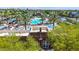 Aerial view of a refreshing community pool area with palm trees and well-maintained lounge areas for relaxation and recreation at 21166 W Main St, Buckeye, AZ 85396