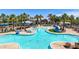 Inviting community pool area featuring a sprawling pool, lounge chairs, cabanas, and lush palm trees at 21166 W Main St, Buckeye, AZ 85396
