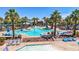 Inviting pool area features a large freeform pool, palm trees, lounge chairs, and shade structures for a perfect outdoor retreat at 21166 W Main St, Buckeye, AZ 85396
