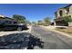 This street view shows well kept homes, street, parked car, and blue sky at 21166 W Main St, Buckeye, AZ 85396