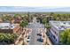 Palm trees line a meticulously designed commercial street with well-maintained buildings and clear blue skies above at 21166 W Main St, Buckeye, AZ 85396