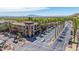 A commercial street scene features lush palm trees alongside buildings, and well-maintained sidewalks, creating an inviting atmosphere at 21166 W Main St, Buckeye, AZ 85396