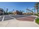 Street view with palm trees lining the road, leading to shops and buildings in the distance at 21166 W Main St, Buckeye, AZ 85396