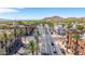 Scenic street view features palm-lined roads, upscale commercial buildings and the backdrop of mountains under a clear sky at 21166 W Main St, Buckeye, AZ 85396