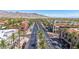 Inviting street view featuring palm-lined roads and varied architectural styles against a backdrop of desert hills and expansive blue sky at 21166 W Main St, Buckeye, AZ 85396