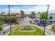 A charming street view showcases lush landscaping and elegant architecture framed by swaying palm trees and a bright blue sky at 21166 W Main St, Buckeye, AZ 85396
