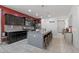 Stylish kitchen features an island with seating, sleek countertops, and stainless steel appliances at 2292 S 236Th Dr, Buckeye, AZ 85326