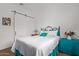 Inviting bedroom with a queen bed, accent pillows, decorative side table, and modern sliding barn door at 24327 N 163Rd Dr, Surprise, AZ 85387