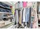 Well-organized closet with clothes hanging on a rod and folded on shelves for easy storage at 24327 N 163Rd Dr, Surprise, AZ 85387