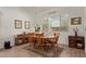 Bright dining room with a wooden table set, decorative rug, and ample natural light at 24327 N 163Rd Dr, Surprise, AZ 85387