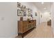 Inviting hallway featuring a stylish accent table adorned with decorative mirrors and artwork at 24327 N 163Rd Dr, Surprise, AZ 85387