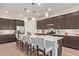 Modern kitchen features an island with seating, stainless steel appliances, and pendant lighting at 24327 N 163Rd Dr, Surprise, AZ 85387