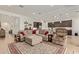 Spacious open-concept living room with an oversized sectional sofa and a seamless transition to the kitchen at 24327 N 163Rd Dr, Surprise, AZ 85387