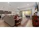 Open-concept living room with neutral decor, a comfortable sectional sofa, and seamless access to outdoor patio at 24327 N 163Rd Dr, Surprise, AZ 85387